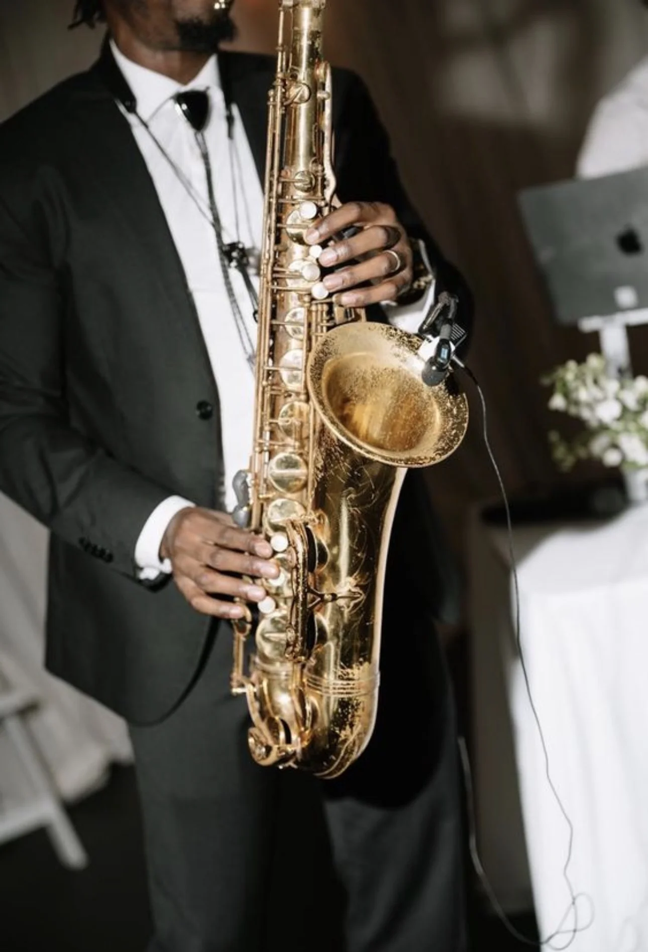 Saxophone player performing jazz in warm tones at a lounge